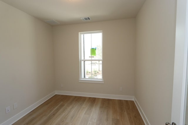 empty room featuring plenty of natural light and light wood-type flooring