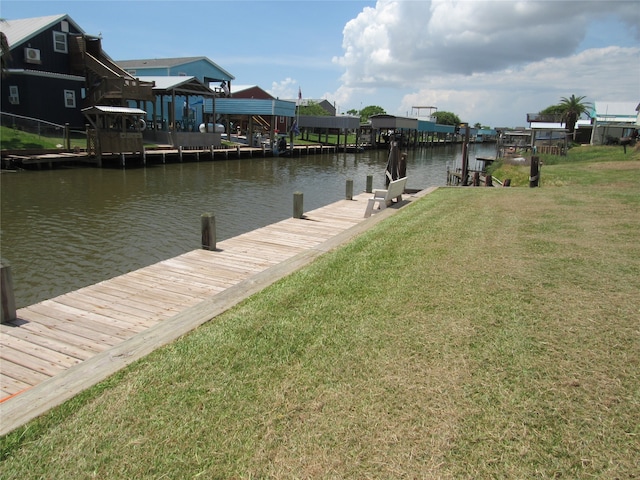 dock area featuring a water view and a yard