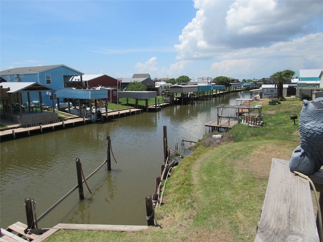 dock area featuring a lawn and a water view