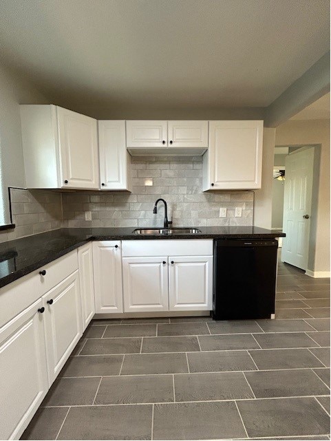 kitchen featuring sink, black dishwasher, white cabinetry, and tasteful backsplash