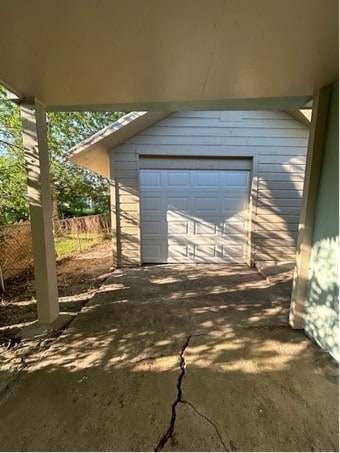 view of patio / terrace featuring an outbuilding and a garage