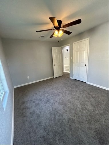 unfurnished bedroom featuring ceiling fan and carpet flooring