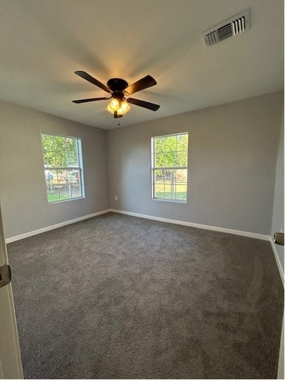 carpeted spare room with ceiling fan