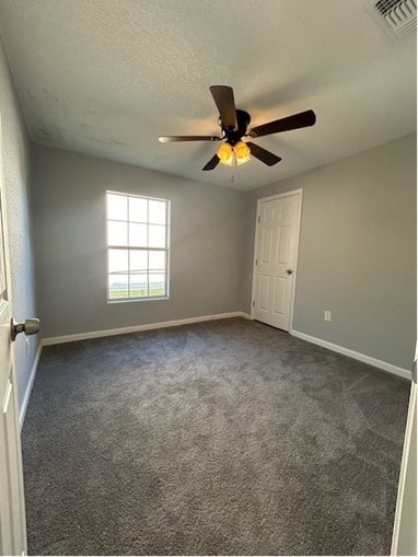 carpeted spare room with ceiling fan