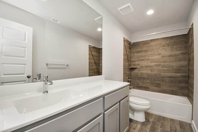 full bath with vanity, toilet, visible vents, wood finished floors, and  shower combination