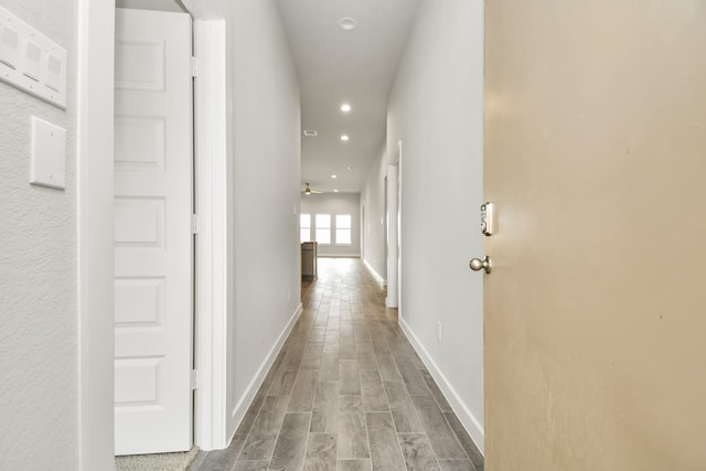 hallway with hardwood / wood-style flooring