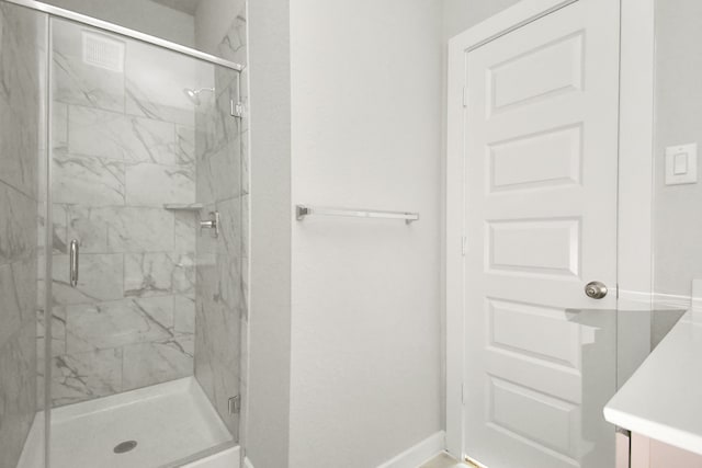 bathroom featuring walk in shower and vanity