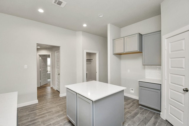 kitchen with baseboards, light wood-style flooring, and gray cabinets