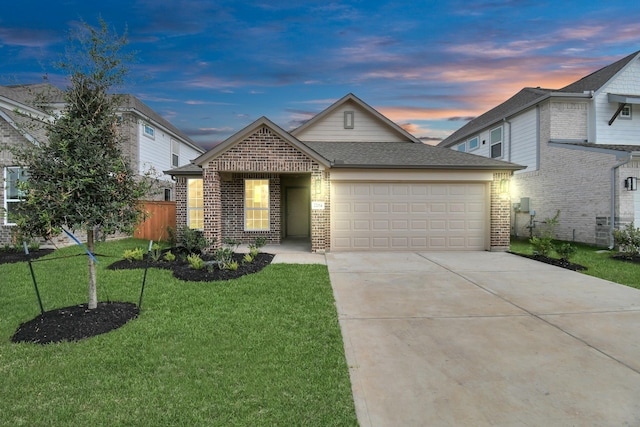 view of front of house featuring driveway, a yard, an attached garage, and brick siding