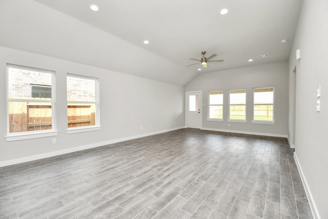 interior space with light hardwood / wood-style floors, lofted ceiling, and ceiling fan