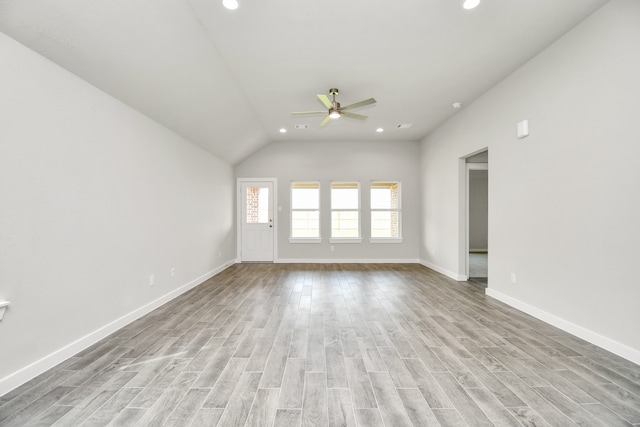 unfurnished room with ceiling fan, light hardwood / wood-style flooring, and lofted ceiling