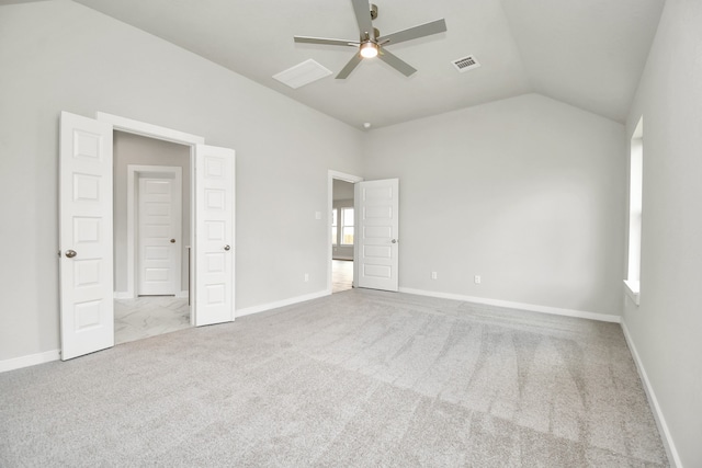 unfurnished bedroom with ceiling fan, light colored carpet, and lofted ceiling