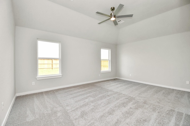 unfurnished room featuring a ceiling fan, visible vents, carpet, baseboards, and lofted ceiling