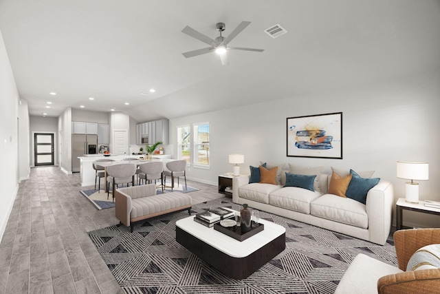 living room featuring recessed lighting, vaulted ceiling, baseboards, light wood-type flooring, and a ceiling fan