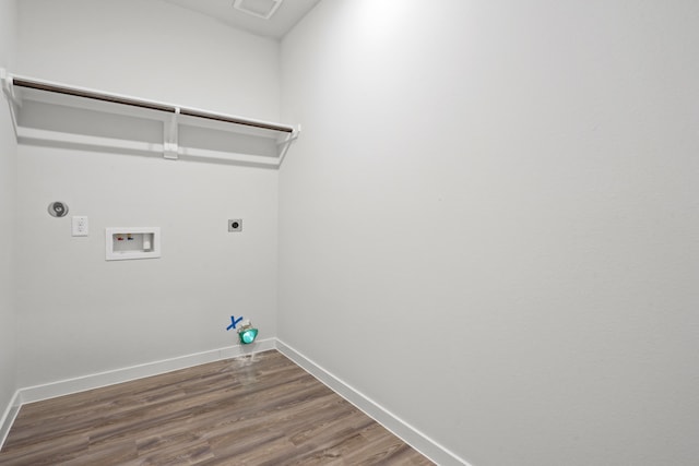 clothes washing area featuring gas dryer hookup, hookup for a washing machine, dark hardwood / wood-style floors, and hookup for an electric dryer