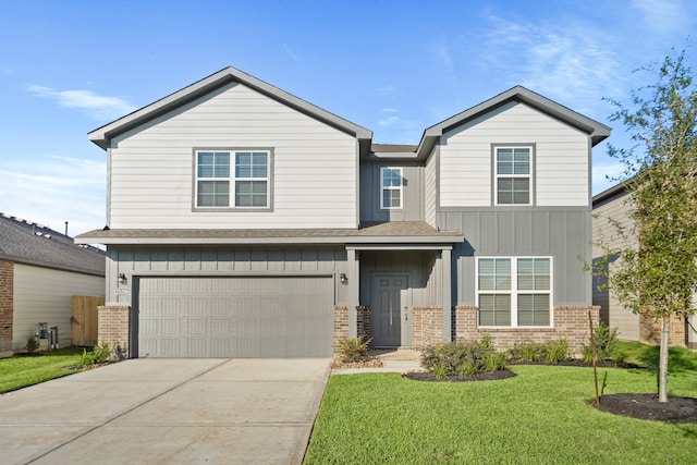 view of front of property with a garage and a front lawn