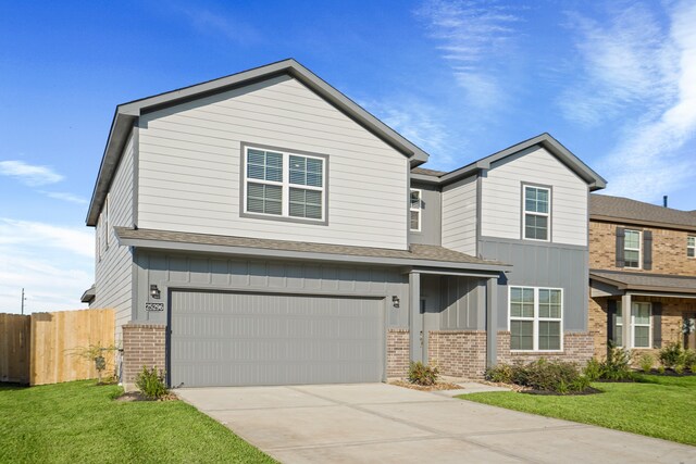 view of front of property featuring a front yard and a garage