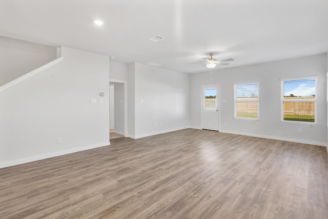 unfurnished living room with ceiling fan and light hardwood / wood-style flooring