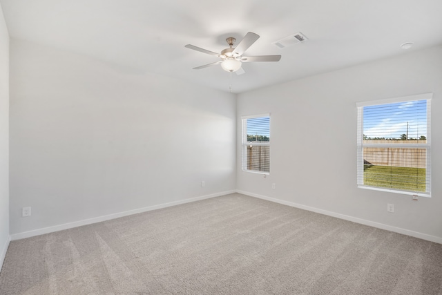 empty room with ceiling fan and light colored carpet