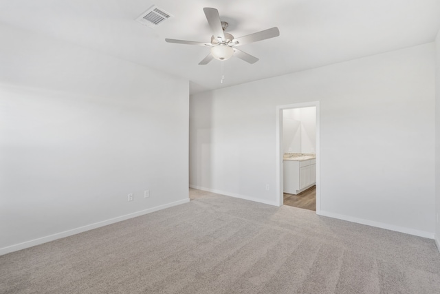 carpeted spare room featuring ceiling fan