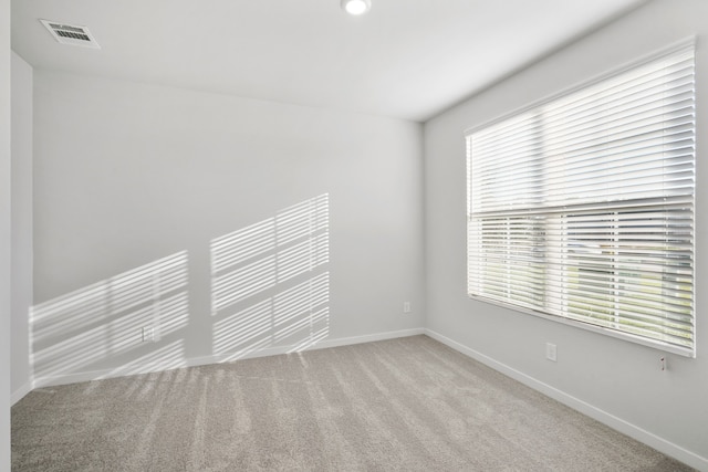 spare room with light colored carpet