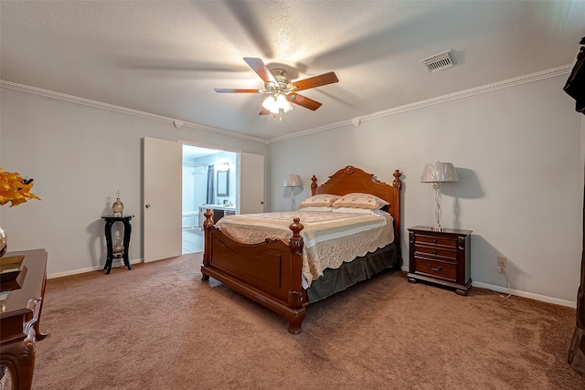 carpeted bedroom featuring a textured ceiling, ceiling fan, crown molding, and ensuite bath