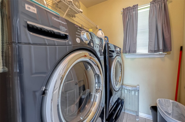 clothes washing area with washing machine and clothes dryer and light tile patterned floors