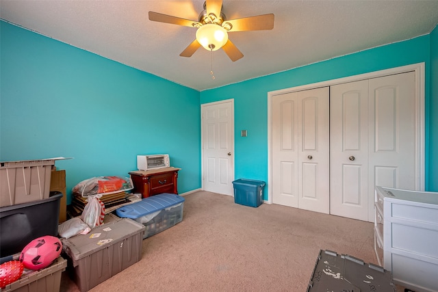 carpeted bedroom with a closet and ceiling fan