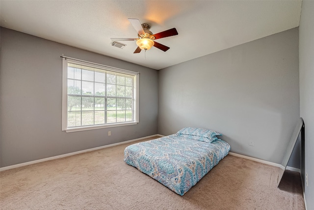 carpeted bedroom featuring ceiling fan