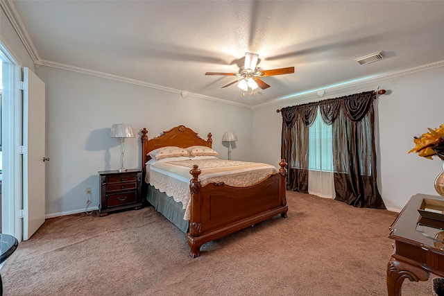 bedroom featuring a textured ceiling, carpet floors, ceiling fan, and ornamental molding