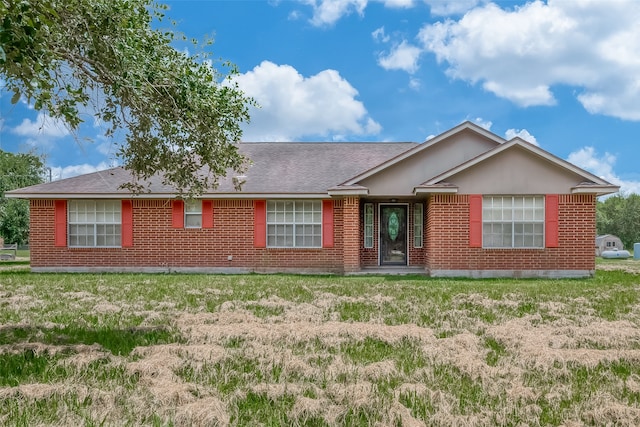 ranch-style home with a front lawn