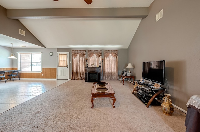 living room featuring ceiling fan, vaulted ceiling with beams, and light tile patterned flooring