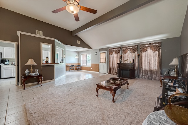 living room with ceiling fan, light tile patterned floors, and lofted ceiling with beams