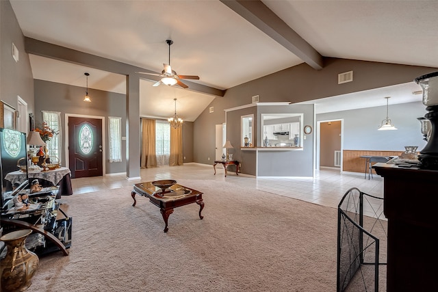 carpeted living room featuring lofted ceiling with beams and ceiling fan with notable chandelier