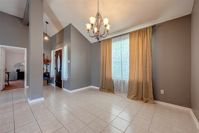 spare room featuring vaulted ceiling, light tile patterned flooring, and a chandelier