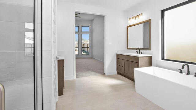 bathroom with vanity and a tub to relax in