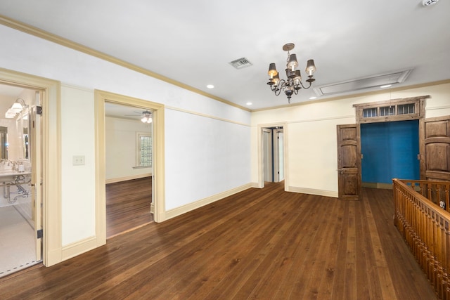 interior space featuring crown molding, ceiling fan with notable chandelier, and dark wood-type flooring