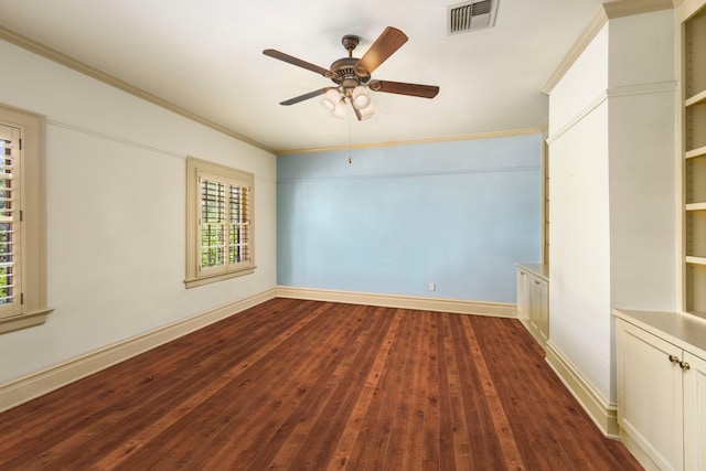 empty room featuring hardwood / wood-style flooring, crown molding, and ceiling fan