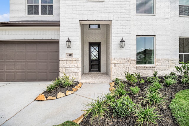 doorway to property with a garage