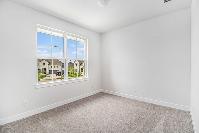 carpeted spare room with a healthy amount of sunlight