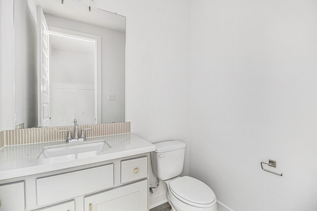 bathroom with toilet and vanity