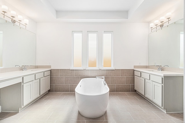 bathroom featuring a bath, tile patterned floors, and vanity