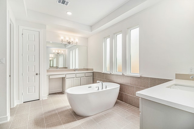 bathroom with a bath, tile walls, tile patterned flooring, and vanity