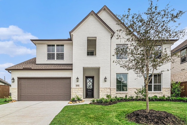 view of front of home featuring a front yard and a garage