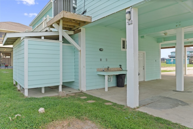 view of exterior entry featuring a lawn