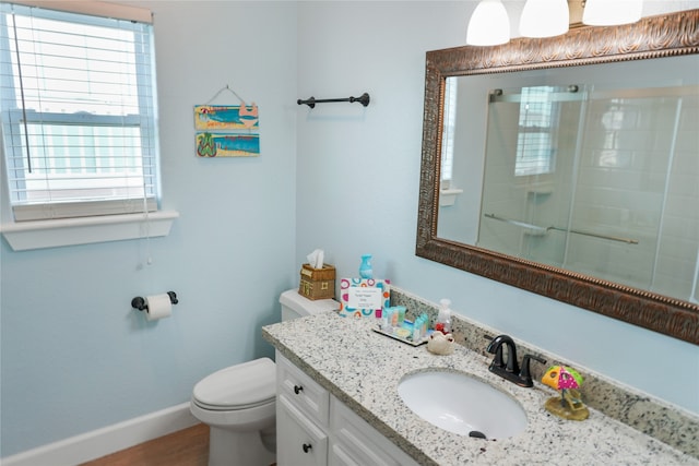 bathroom with vanity, toilet, and walk in shower