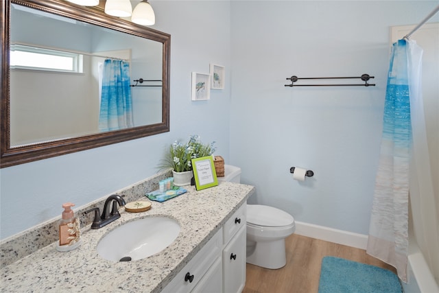 bathroom featuring a shower with shower curtain, vanity, toilet, and hardwood / wood-style flooring