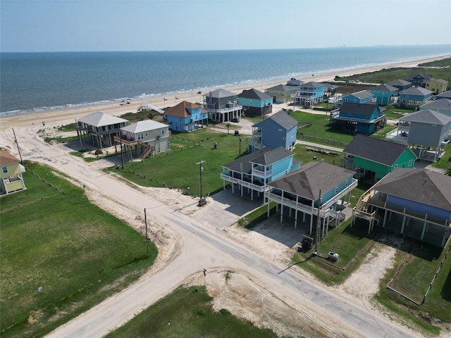 bird's eye view with a residential view, a water view, and a beach view