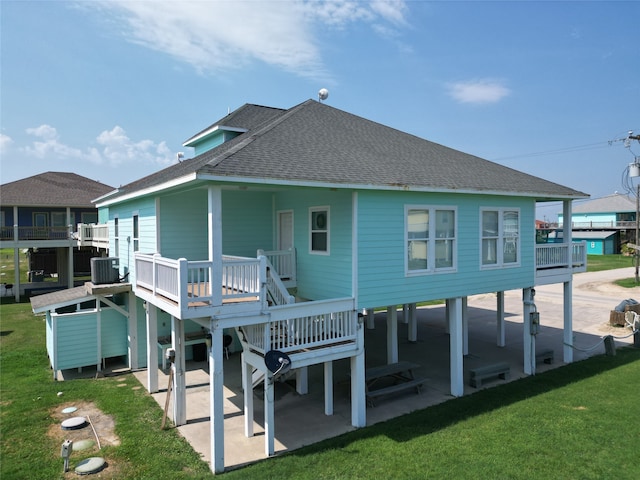 back of property with a lawn, a patio area, and central air condition unit