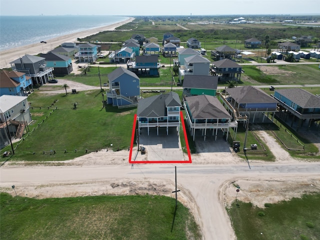 birds eye view of property featuring a beach view and a water view